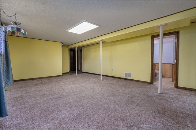 basement featuring carpet floors and a textured ceiling