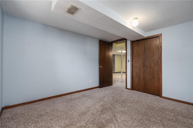 unfurnished bedroom featuring a closet and carpet flooring