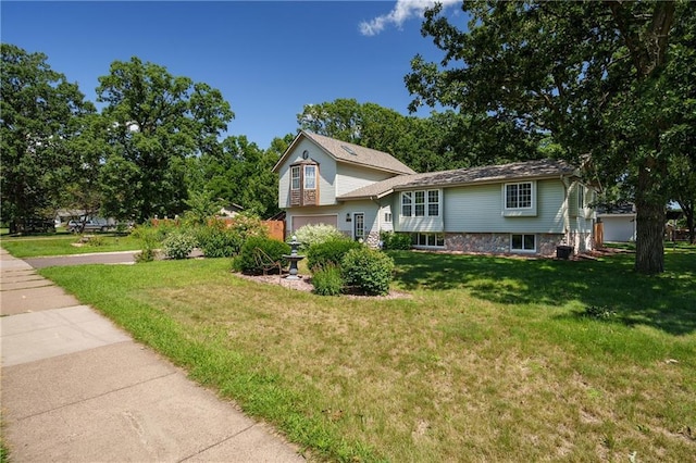 tri-level home with a front lawn