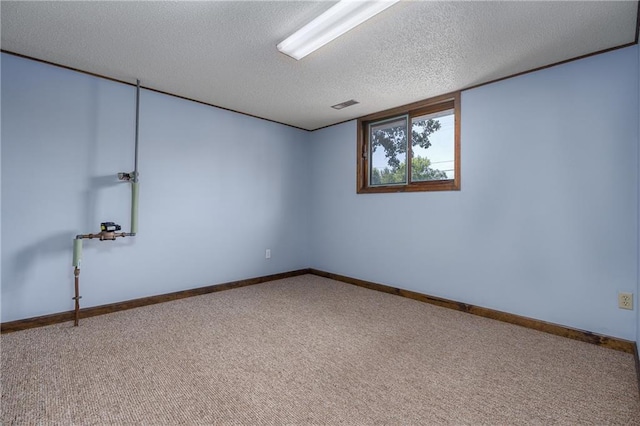 carpeted spare room with a textured ceiling