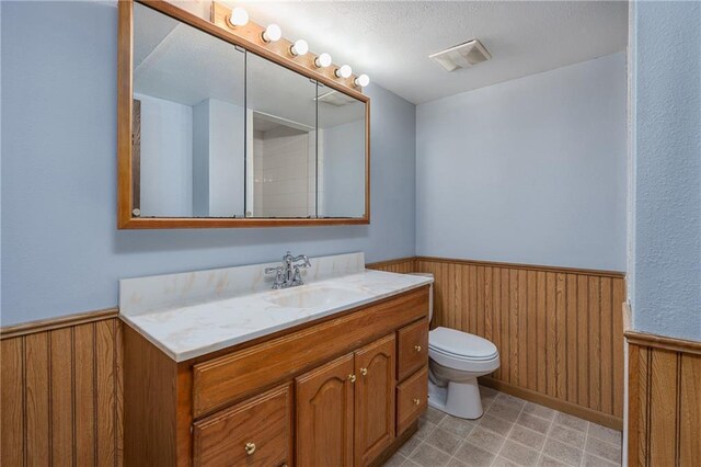 bathroom with vanity, tile patterned floors, and toilet