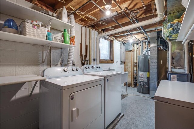 laundry area featuring washing machine and clothes dryer and gas water heater