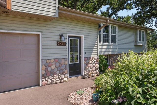 view of exterior entry with a garage