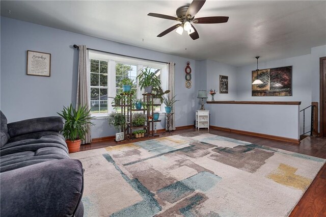 living room with wood-type flooring and ceiling fan