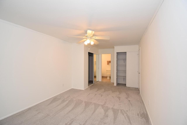 empty room with ceiling fan and light carpet