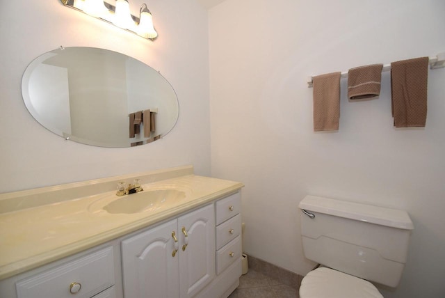 bathroom with tile patterned flooring, vanity, and toilet