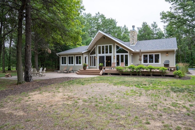 back of house with a patio, a yard, and a deck