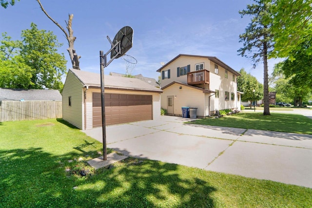 view of front of property featuring a garage, a front yard, and a balcony