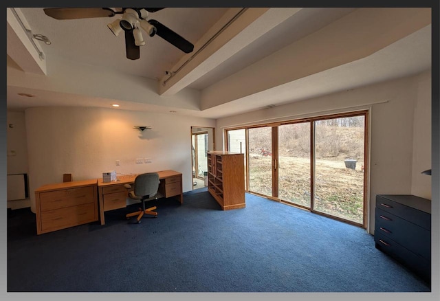 office with ceiling fan, a healthy amount of sunlight, built in desk, and dark carpet