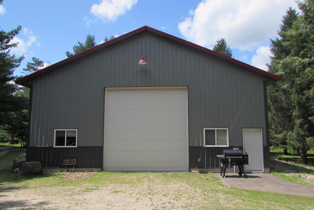 view of property exterior featuring a garage and an outbuilding