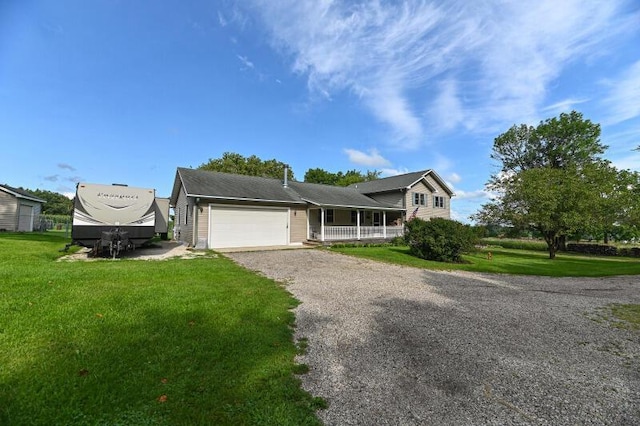 view of front of property featuring a porch, a garage, and a front lawn