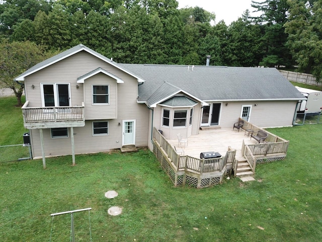 back of house with a wooden deck and a yard