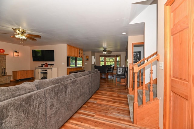 living room featuring light wood-type flooring and ceiling fan