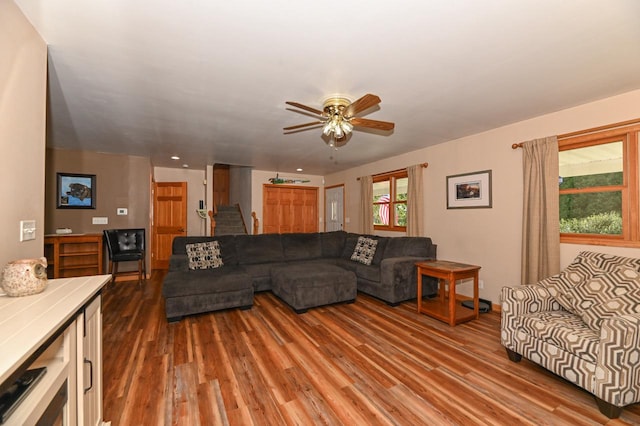 living room featuring ceiling fan and hardwood / wood-style flooring