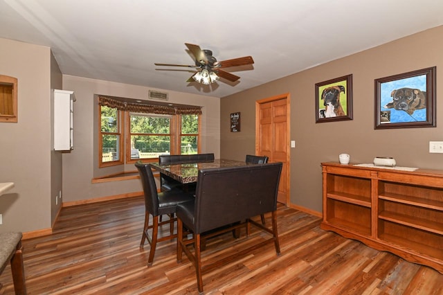 dining area featuring dark hardwood / wood-style flooring and ceiling fan