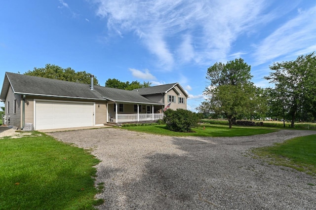 view of front of house featuring a garage, a porch, and a front lawn