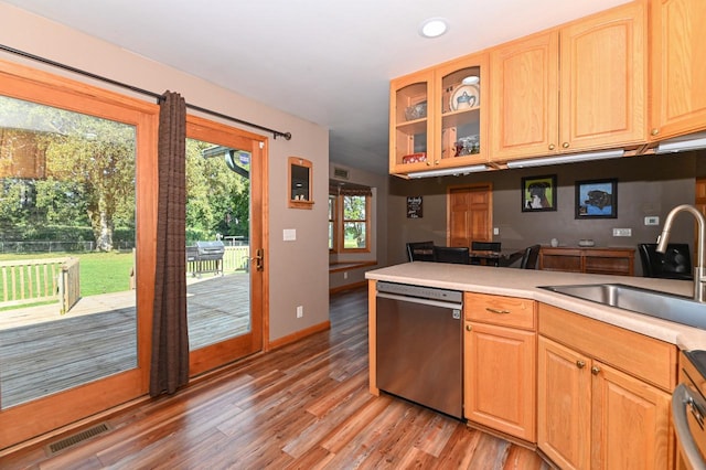 kitchen featuring stainless steel dishwasher, light brown cabinetry, sink, and light hardwood / wood-style flooring