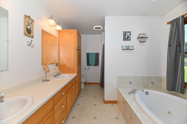 bathroom featuring tiled tub, dual bowl vanity, toilet, and tile patterned floors