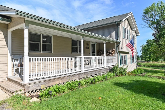 view of home's exterior with a lawn and a porch