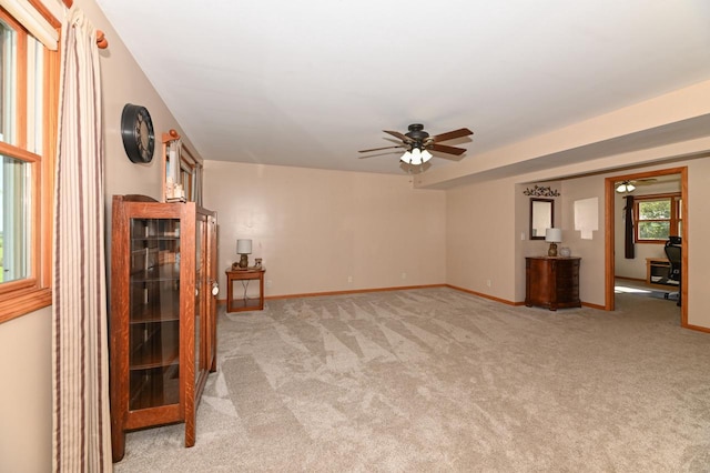 unfurnished living room with ceiling fan and light carpet