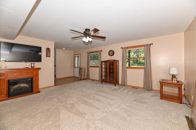 carpeted living room with ceiling fan