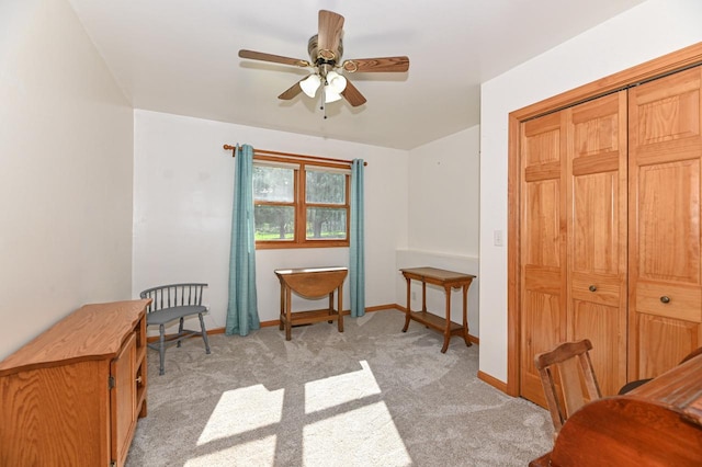 office space with ceiling fan and light colored carpet