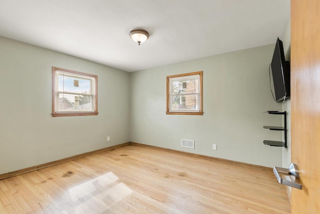 empty room featuring a healthy amount of sunlight and light wood-type flooring