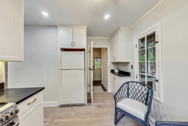 kitchen featuring white fridge, white cabinetry, a wealth of natural light, and light hardwood / wood-style floors