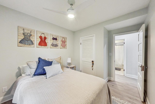 bedroom featuring light hardwood / wood-style flooring, a closet, and ceiling fan