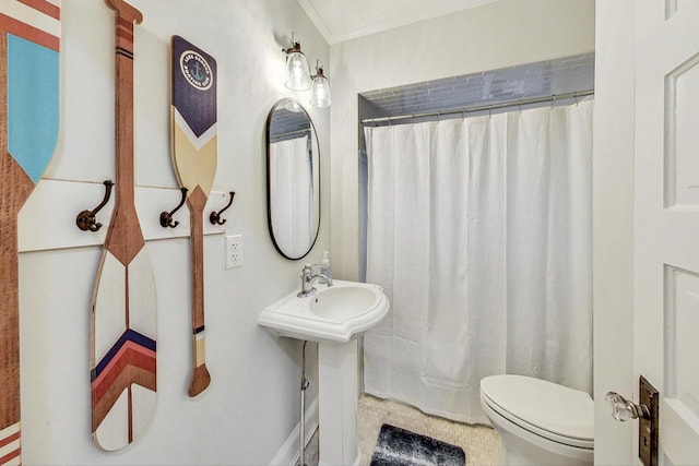 bathroom featuring toilet and crown molding