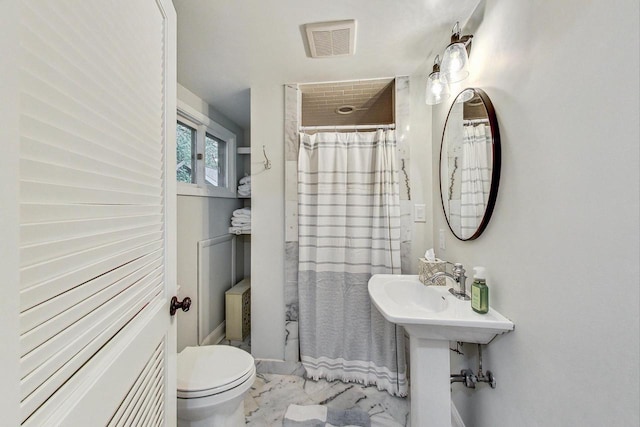 bathroom with tile patterned flooring and toilet