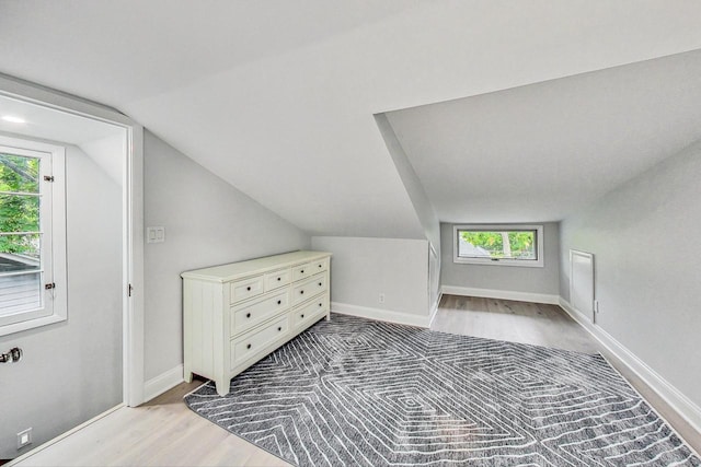 bonus room featuring a healthy amount of sunlight, vaulted ceiling, and light hardwood / wood-style floors