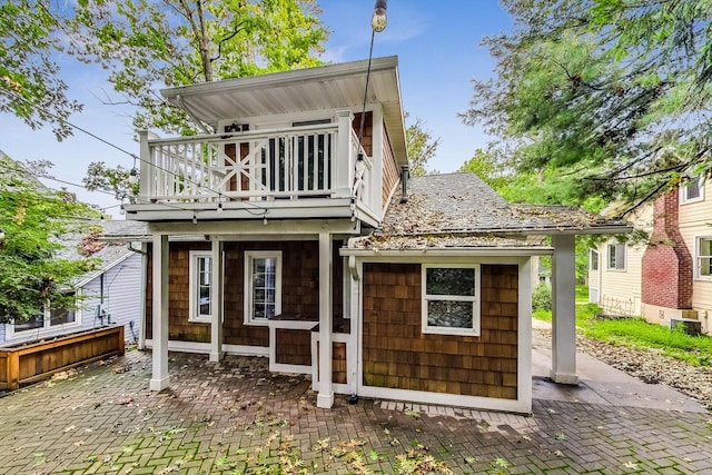 back of property with a balcony