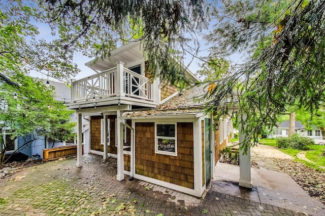 back of house featuring a balcony