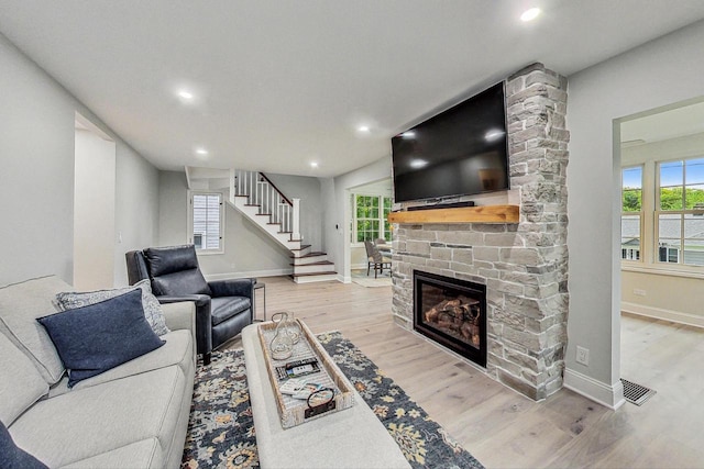 living room with a fireplace and light hardwood / wood-style floors