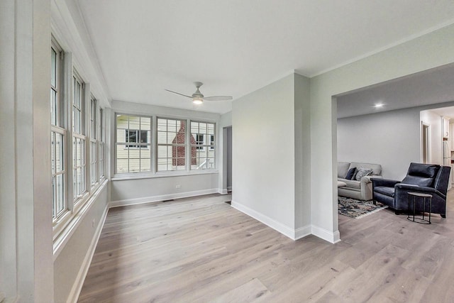 sunroom / solarium featuring ceiling fan