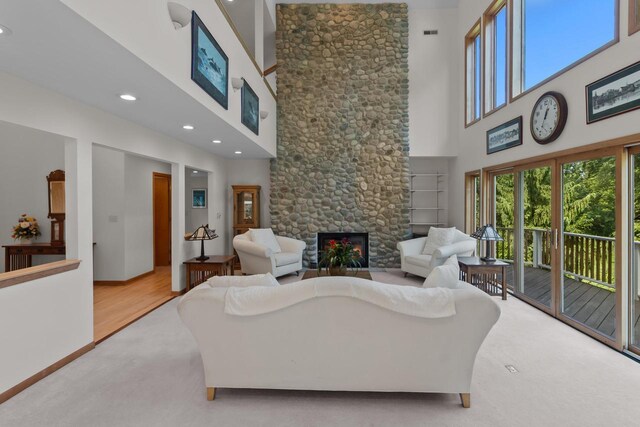 carpeted bedroom featuring high vaulted ceiling, access to exterior, and multiple windows