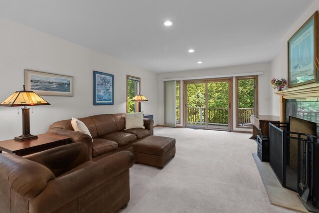 living room with light carpet and a high end fireplace