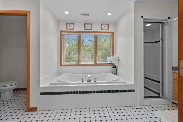 bathroom featuring separate shower and tub, tile patterned flooring, and toilet