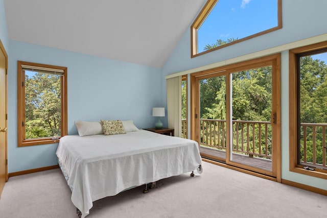 carpeted bedroom featuring high vaulted ceiling, multiple windows, and access to exterior