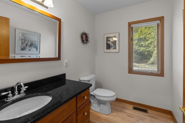 bathroom featuring hardwood / wood-style floors, vanity, and toilet