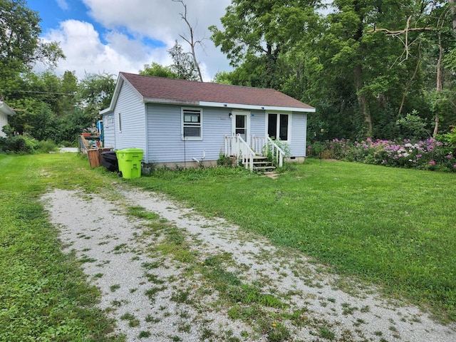 rear view of property with a lawn