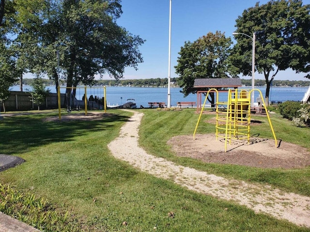 exterior space featuring a lawn and a water view