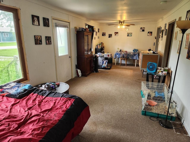 bedroom with carpet, crown molding, and ceiling fan