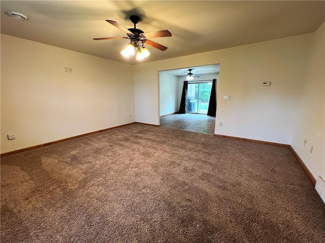 carpeted spare room with ceiling fan