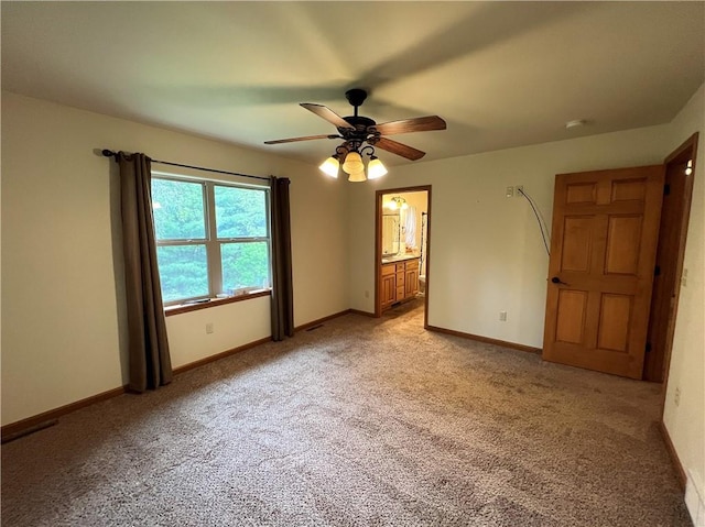 unfurnished room featuring ceiling fan and light carpet