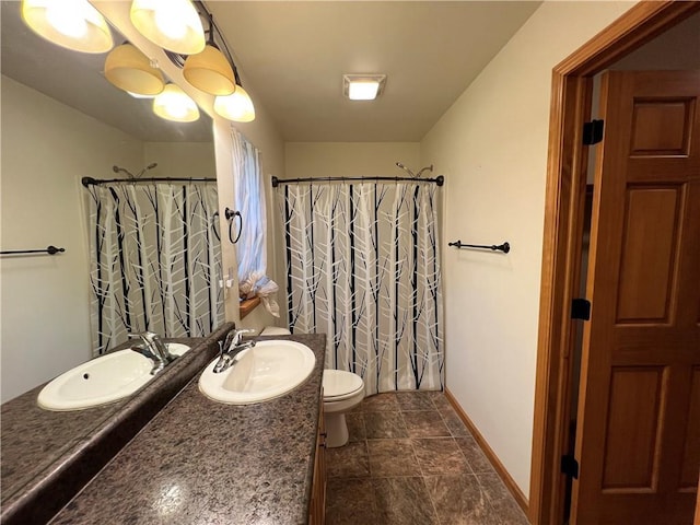 bathroom featuring toilet, tile patterned floors, and vanity