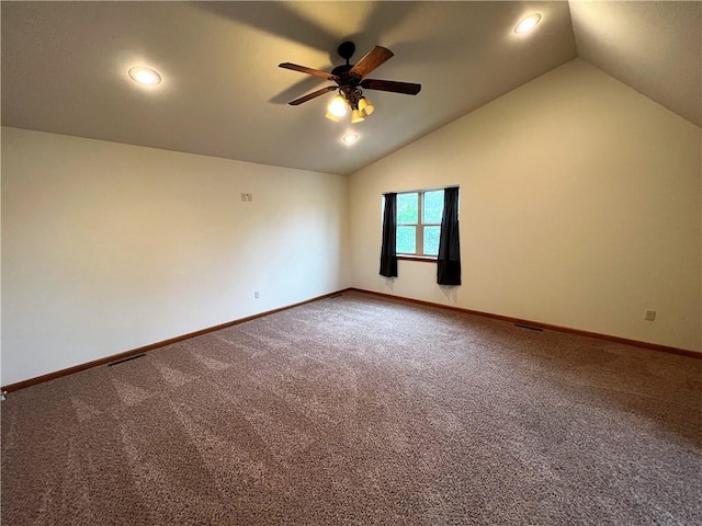 carpeted empty room with ceiling fan and lofted ceiling