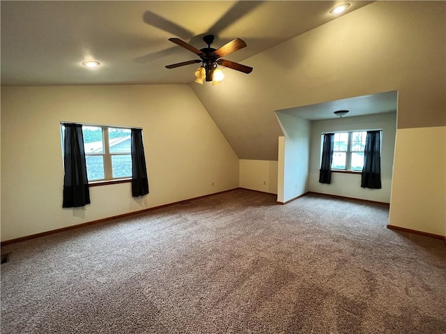 additional living space featuring ceiling fan, carpet flooring, and vaulted ceiling