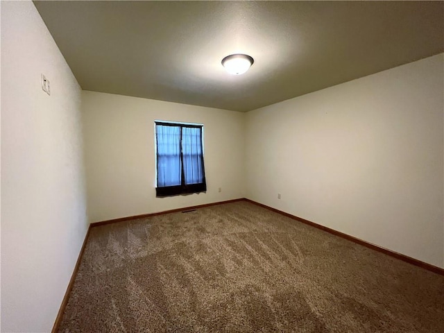 unfurnished room featuring carpet